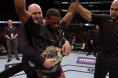 Dana White puts the belt on UFC welterweight champ Tyron Woodley
