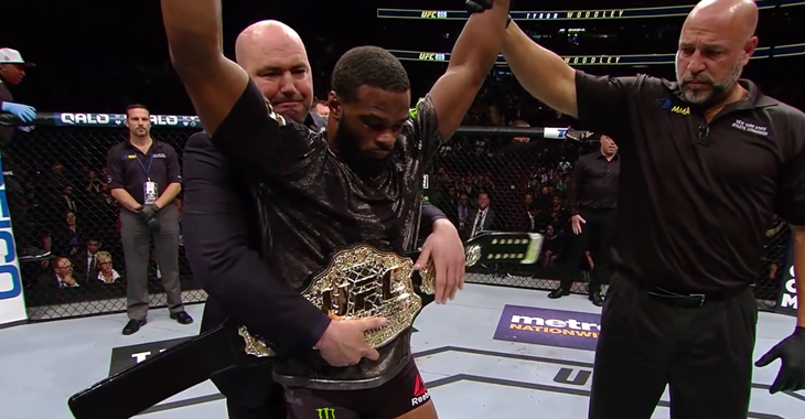 Dana White puts the belt on UFC welterweight champ Tyron Woodley