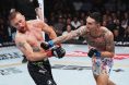 Max Holloway punches Justin Gaethje UFC 300