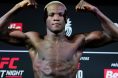 Losene Keita poses on the scale during the UFC Paris official weigh-ins