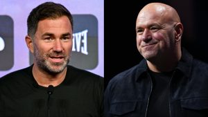 Eddie Hearn speaks at a press conference, opposite Dana White on stage at a media event