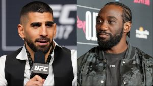 Ilia Topuria answers a question during the UFC 317 press conference, opposite Terence Crawford during a media day interview