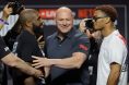Dana White separates two fighters after a faceoff during a press conference