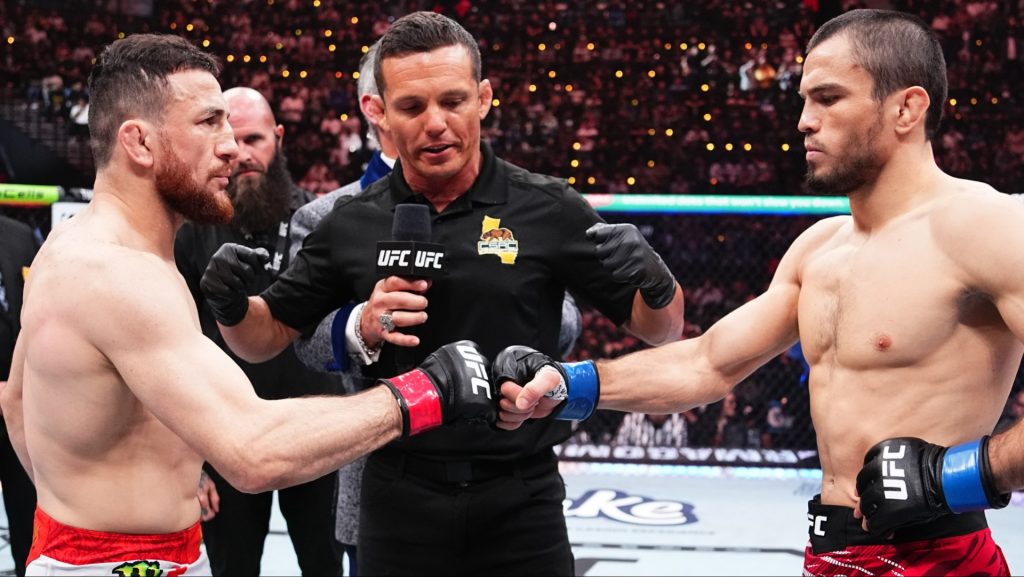 Merab Dvalishvili and Umar Nurmagomedov touch gloves just before their UFC 311 title fight