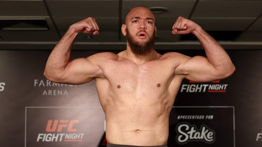 Valter Walker poses on the scale at the UFC Rio official weigh-in