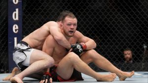 Merab Dvalishvili grapples with Petr Yan during their fight in Las Vegas