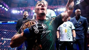 Tom Aspinall celebrates after winning the UFC interim heavyweight title at UFC 295
