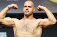 Martin Buday poses on the scale at the UFC Abu Dhabi ceremonial weigh-in