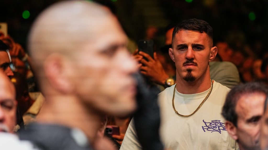 Tom Aspinall looks on after Alex Pereira wins at UFC 300