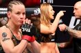 Valentina Shevchenko enters the Octagon at UFC 315, opposite Joe Rogan interviewing Ronda Rousey at a ceremonial weigh-in