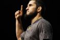 Islam Makhachev poses on the scale at the UFC 311 ceremonial weigh-in
