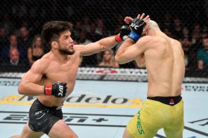 Henry Cejudo throws punch at Marlon Moraes