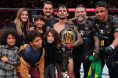 Alexandre Pantoja poses for a photo with his family after his win at UFC 296