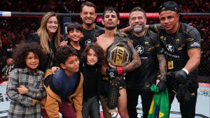 Alexandre Pantoja poses for a photo with his family after his win at UFC 296