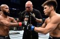 Demetrious Johnson and Henry Cejudo touch gloves just before their fight