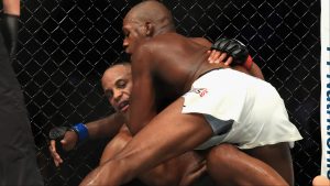Jon Jones grapples with Daniel Cormier during their fight at UFC 214