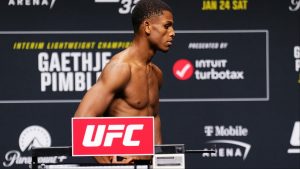 Cameron Smotherman poses on the scale at the UFC 324 official weigh-in