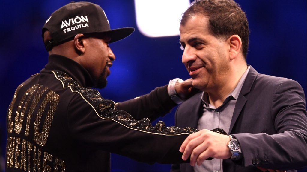 Floyd Mayweather and Showtime executive Stephen Espinoza embrace at a post-fight press conference