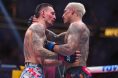 Charles Oliveira and Max Holloway embrace at UFC 326
