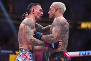 Charles Oliveira and Max Holloway embrace at UFC 326