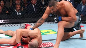 Carlos Ulberg punches a downed Jiri Prochazka at UFC 327