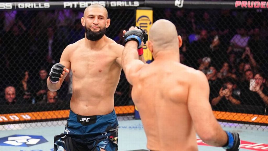 Khamzat Chimaev and Sean Strickland touch gloves at the start of UFC 328 headliner
