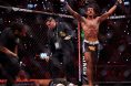 Adriano Moraes celebrates after submitting Phumi Nkuta as referee Herb Dean intervenes
