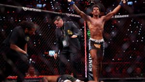 Adriano Moraes celebrates after submitting Phumi Nkuta as referee Herb Dean intervenes