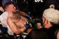 Conor McGregor is escorted from T-Mobile Arena at UFC 264