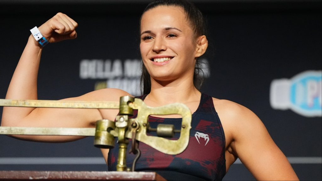 Erin Blanchfield poses on the scale at the UFC 322 ceremonial weigh-in