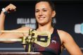 Erin Blanchfield poses on the scale at the UFC 322 ceremonial weigh-in