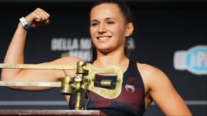 Erin Blanchfield poses on the scale at the UFC 322 ceremonial weigh-in