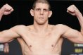 Joe Lauzon poses on the scale at the UFC 274 weigh-in