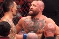 Conor McGregor speaks with Max Holloway after UFC 329