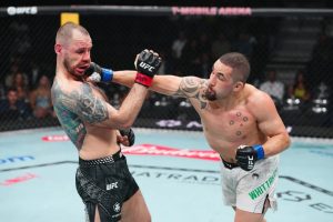 Robert Whittaker lands a punch on Nikita Krylov on his way to a TKO win at UFC 329
